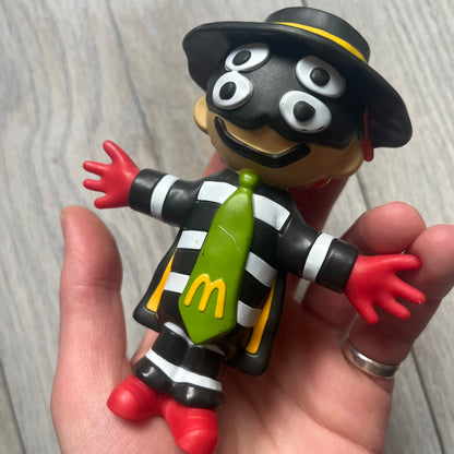 The CPFM x McDonald’s Hamburglar Figure from the FW22 adult Happy Meal drop features the classic character in his striped outfit, red gloves, and green McDonald’s tie, reimagined with CPFM’s four-eye design. Licensed on the back and released October 3rd, 2022.