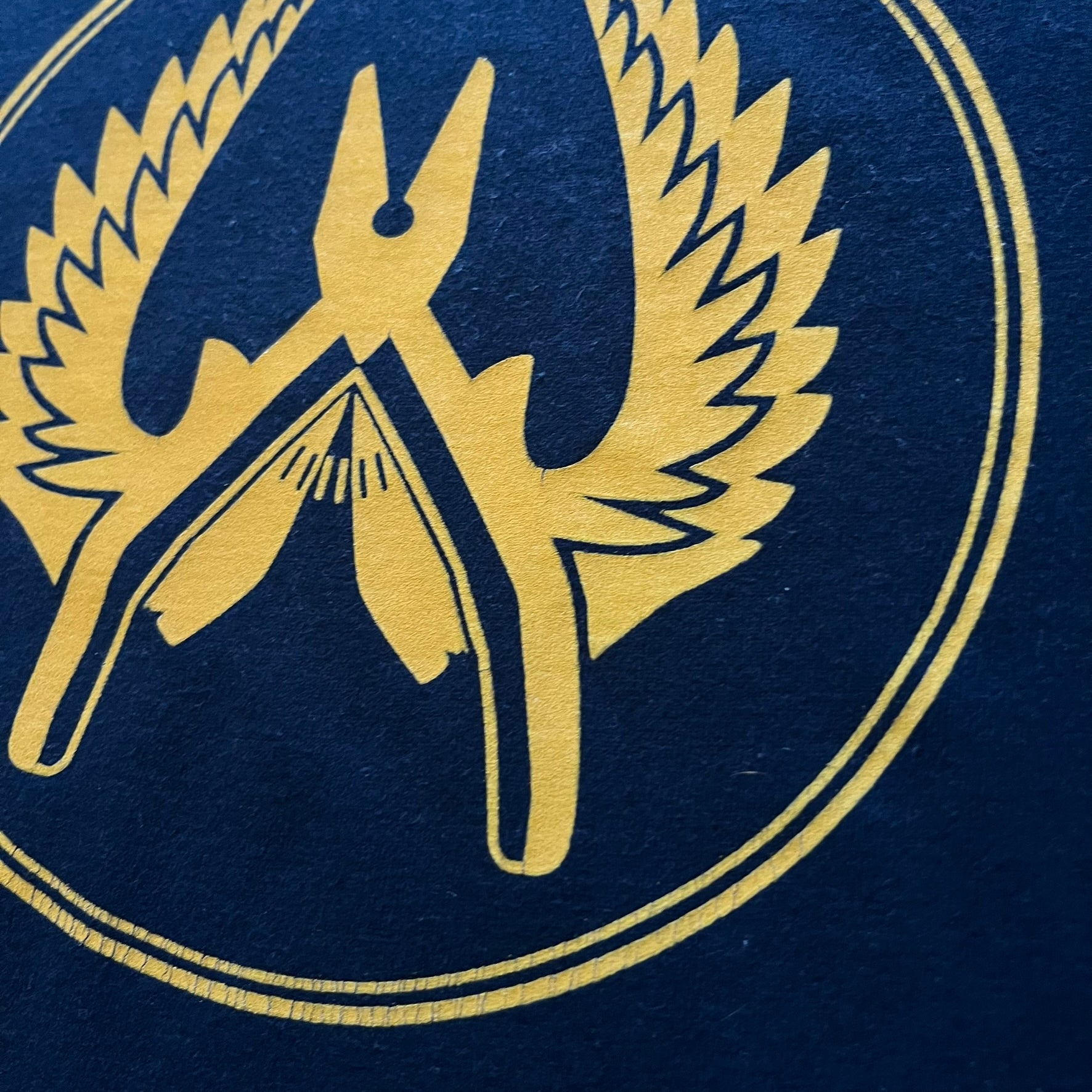 CS:GO 2015 Defuse Kit tee in navy, featuring a bright yellow defuse kit logo on the chest and a small yellow CS:GO patch on the sleeve. Made in Nicaragua from a 60/40 cotton-polyester blend, it includes licensed 2016 Valve Corporation and Counter-Strike Global Offensive tags. A collectible gaming tee that celebrates one of the most iconic in-game items from the series.