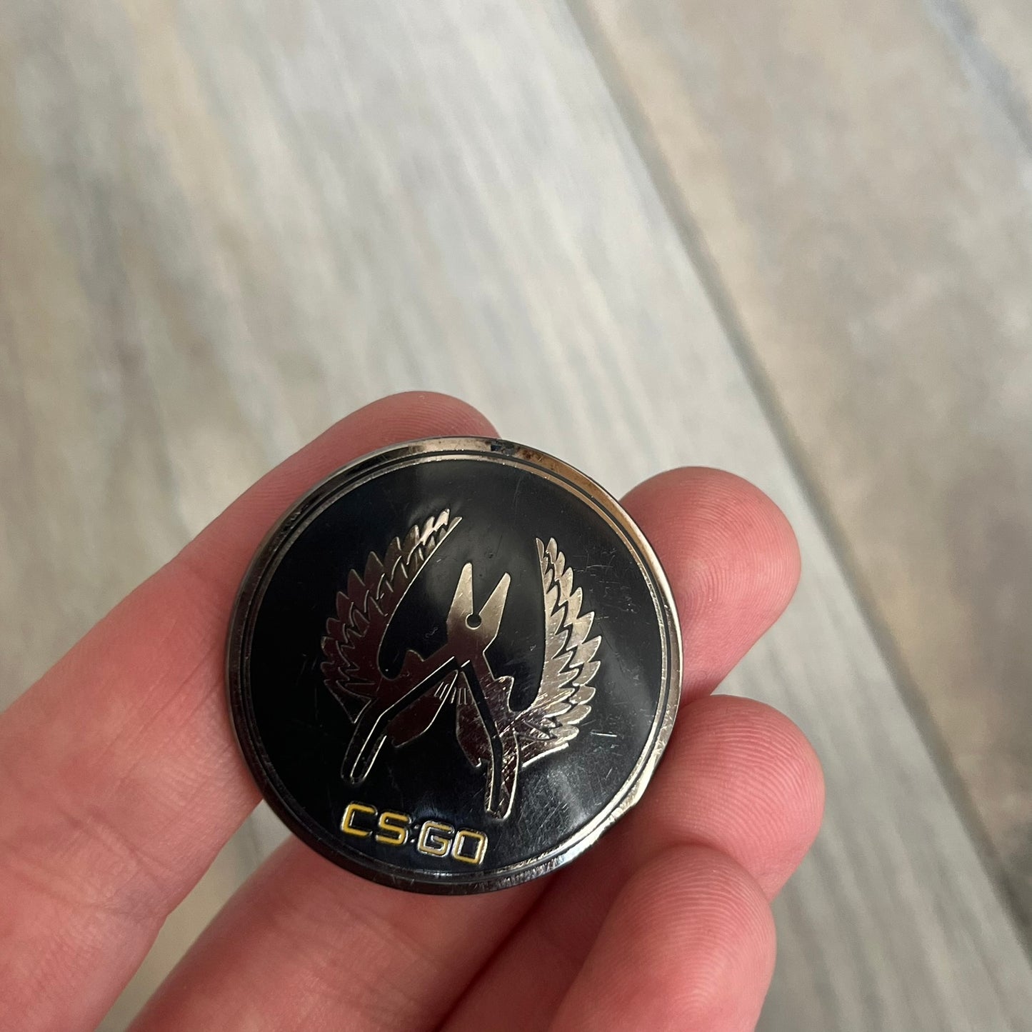 Original physical Counter-Strike: Global Offensive Series 1 Elite Guardian pin, produced as official Valve merchandise. These pins were sold at Valve-sponsored CS:GO Major events and later through the official WeLoveFine store, and originally included a code to unlock a “Genuine” in-game digital pin on a Steam profile. This example comes without the packaging and the in-game code.