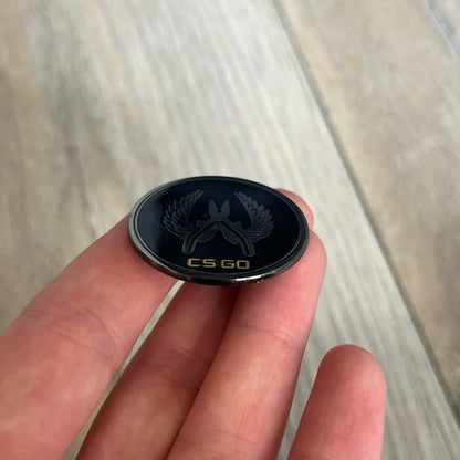 Original physical Counter-Strike: Global Offensive Series 1 Elite Guardian pin, produced as official Valve merchandise. These pins were sold at Valve-sponsored CS:GO Major events and later through the official WeLoveFine store, and originally included a code to unlock a “Genuine” in-game digital pin on a Steam profile. This example comes without the packaging and the in-game code.