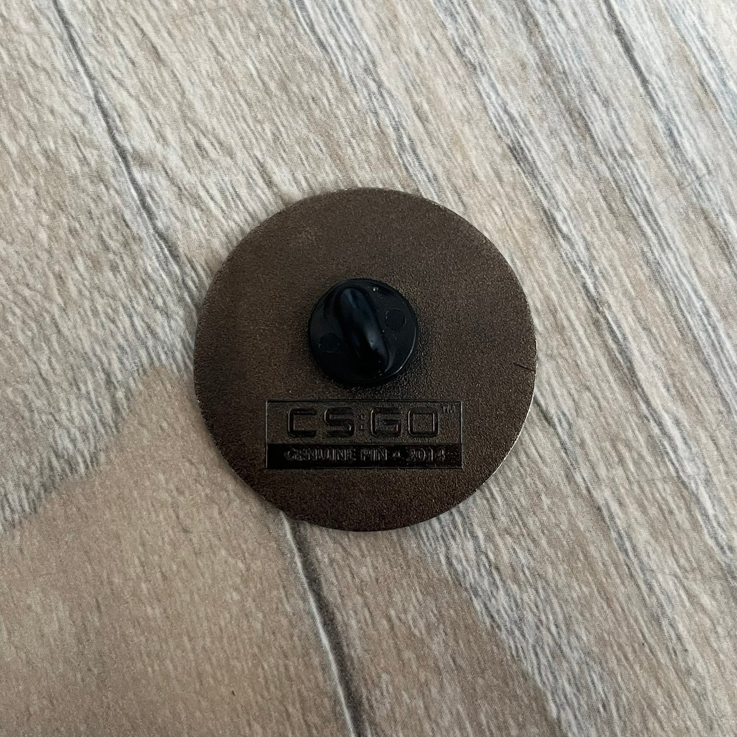 Original physical Counter-Strike: Global Offensive Series 1 Elite Guardian pin, produced as official Valve merchandise. These pins were sold at Valve-sponsored CS:GO Major events and later through the official WeLoveFine store, and originally included a code to unlock a “Genuine” in-game digital pin on a Steam profile. This example comes without the packaging and the in-game code.