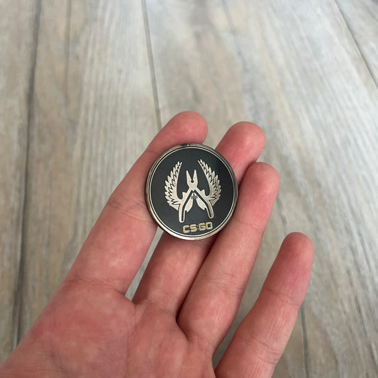 Original physical Counter-Strike: Global Offensive Series 1 Elite Guardian pin, produced as official Valve merchandise. These pins were sold at Valve-sponsored CS:GO Major events and later through the official WeLoveFine store, and originally included a code to unlock a “Genuine” in-game digital pin on a Steam profile. This example comes without the packaging and the in-game code.