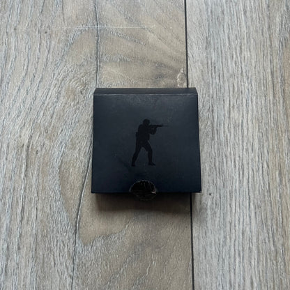 Original physical Counter-Strike: Global Offensive Series 1 Guardian pin, produced as official Valve merchandise. These pins were sold at Valve-sponsored CS:GO Major events and later through the official WeLoveFine store, and originally included a code to unlock a “Genuine” in-game digital pin on a Steam profile. This example comes complete with the original packaging; the code has been scratched and is already used.
