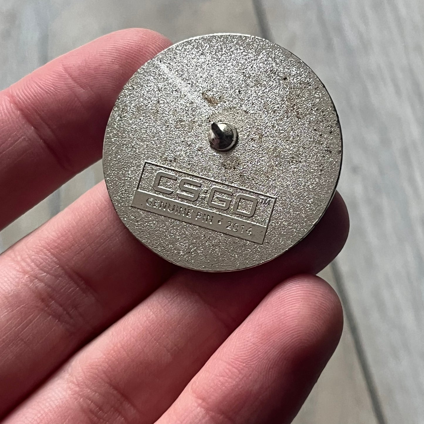 Original physical Counter-Strike: Global Offensive Series 1 Guardian pin, produced as official Valve merchandise. These pins were sold at Valve-sponsored CS:GO Major events and later through the official WeLoveFine store, and originally included a code to unlock a “Genuine” in-game digital pin on a Steam profile. This example comes complete with the original packaging; the code has been scratched and is already used.