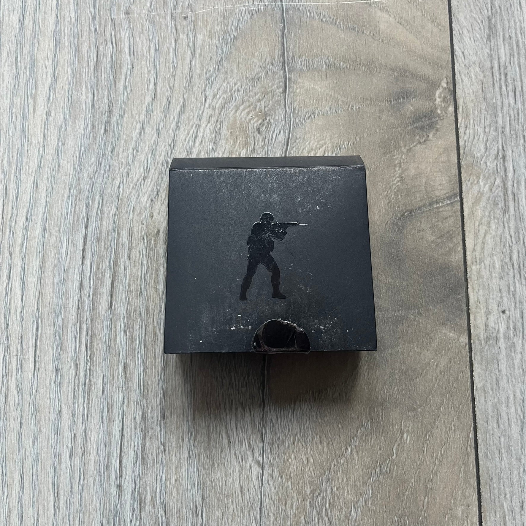 Original physical Counter-Strike: Global Offensive Series 1 Nuke pin, produced as official Valve merchandise. These pins were sold at Valve-sponsored CS:GO Major events and later via the official WeLoveFine store, and originally included a code to unlock a “Genuine” Nuke pin for the user’s Steam profile. This example comes with the original packaging; the code has been scratched (by me) but remains unused.