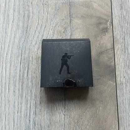 Original physical Counter-Strike: Global Offensive Series 1 Nuke pin, produced as official Valve merchandise. These pins were sold at Valve-sponsored CS:GO Major events and later via the official WeLoveFine store, and originally included a code to unlock a “Genuine” Nuke pin for the user’s Steam profile. This example comes with the original packaging; the code has been scratched (by me) but remains unused.