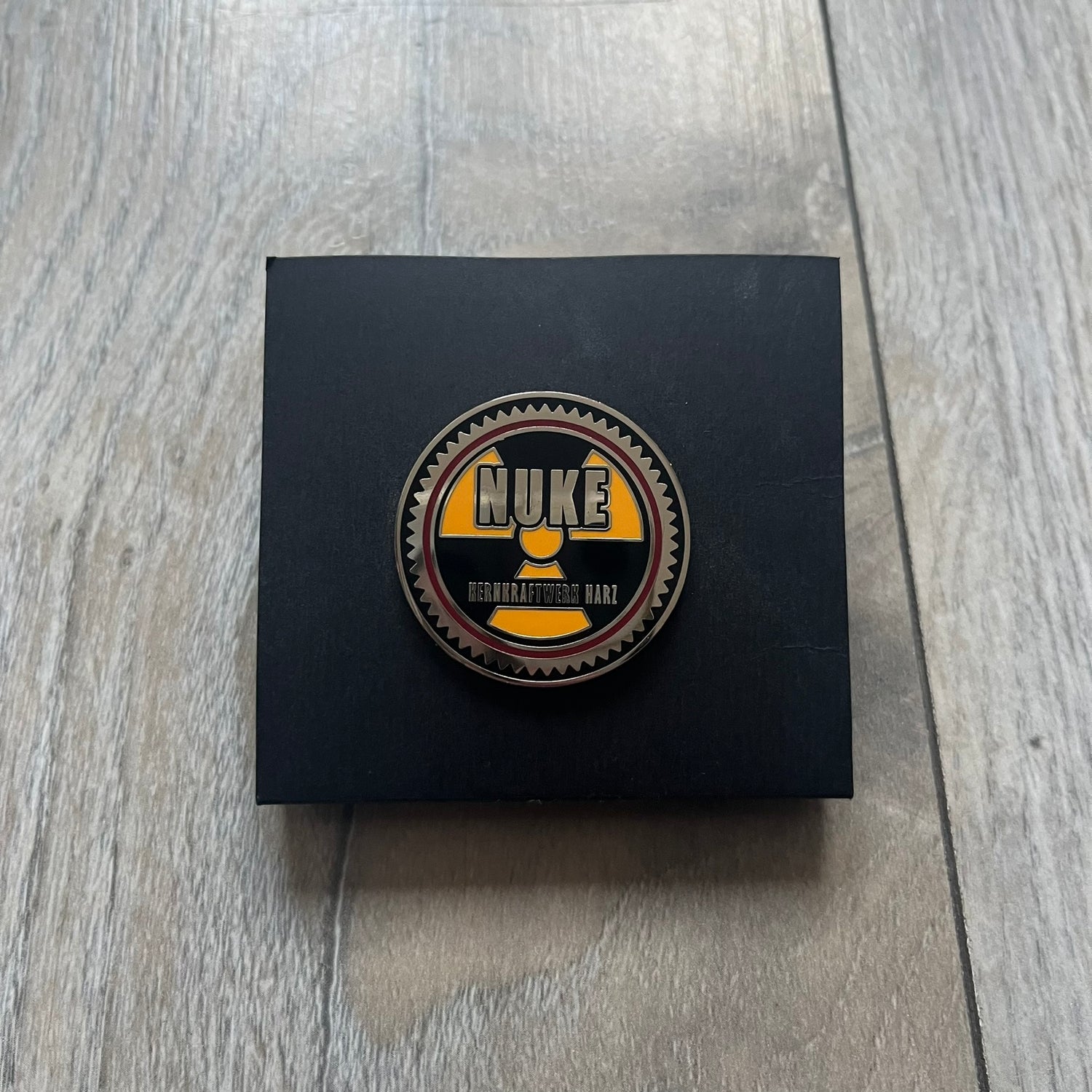 Original physical Counter-Strike: Global Offensive Series 1 Nuke pin, produced as official Valve merchandise. These pins were sold at Valve-sponsored CS:GO Major events and later via the official WeLoveFine store, and originally included a code to unlock a “Genuine” Nuke pin for the user’s Steam profile. This example comes with the original packaging; the code has been scratched (by me) but remains unused.