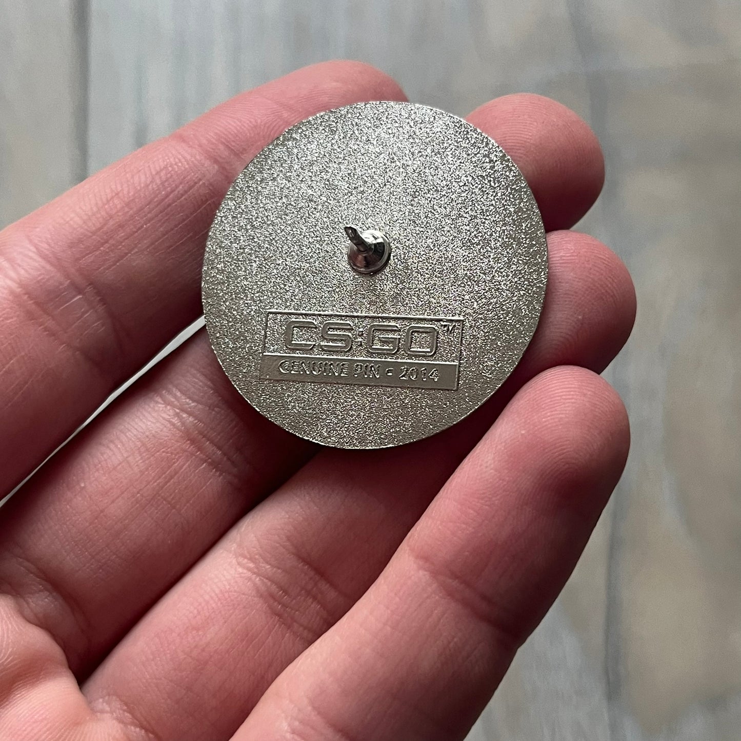 Original physical Counter-Strike: Global Offensive Series 1 Nuke pin, produced as official Valve merchandise. These pins were sold at Valve-sponsored CS:GO Major events and later via the official WeLoveFine store, and originally included a code to unlock a “Genuine” Nuke pin for the user’s Steam profile. This example comes with the original packaging; the code has been scratched (by me) but remains unused.