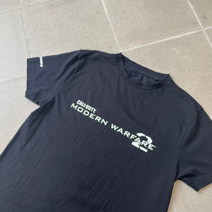 Call of Duty: Modern Warfare 2 2010s Tee features a simple design with the Call of Duty: Modern Warfare 2 logo printed on the front in white and green. The sleeve includes an Infinity Ward logo detail, while the neck has a basic size tag. A later 2010s release inspired by the iconic Modern Warfare 2 branding, not the original promotional tee.
