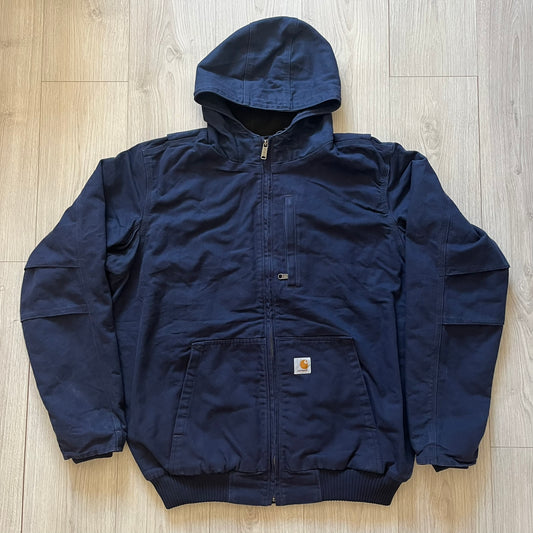 Carhartt Armstrong Full Swing Active Jacket in navy, crafted from heavyweight 12-ounce fleece-lined cotton duck for warmth and durability. Designed with stretch panels across the back and elbows, it allows full range of motion while maintaining a broken-in, comfortable fit. Features include a fleece-lined adjustable hood, rib-knit storm cuffs and waist, triple-stitched main seams, and multiple secure pockets, making it a trusted workwear piece with modernized functionality.