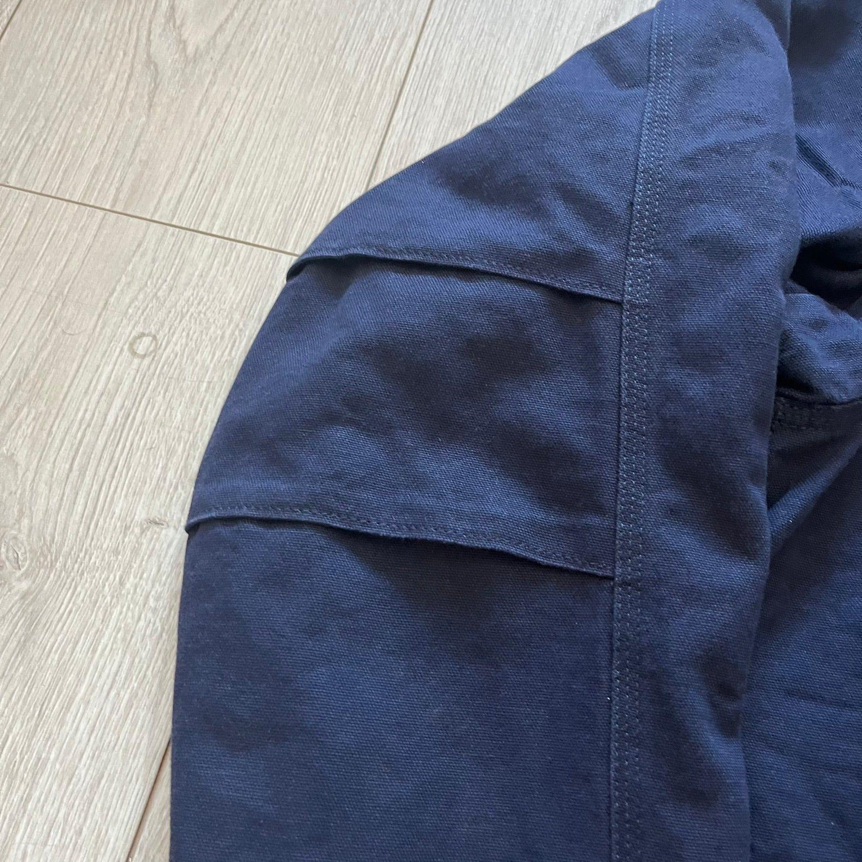 Carhartt Armstrong Full Swing Active Jacket in navy, crafted from heavyweight 12-ounce fleece-lined cotton duck for warmth and durability. Designed with stretch panels across the back and elbows, it allows full range of motion while maintaining a broken-in, comfortable fit. Features include a fleece-lined adjustable hood, rib-knit storm cuffs and waist, triple-stitched main seams, and multiple secure pockets, making it a trusted workwear piece with modernized functionality.