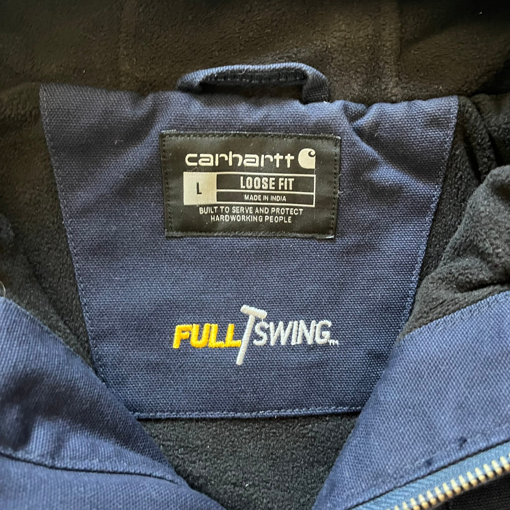 Carhartt Armstrong Full Swing Active Jacket in navy, crafted from heavyweight 12-ounce fleece-lined cotton duck for warmth and durability. Designed with stretch panels across the back and elbows, it allows full range of motion while maintaining a broken-in, comfortable fit. Features include a fleece-lined adjustable hood, rib-knit storm cuffs and waist, triple-stitched main seams, and multiple secure pockets, making it a trusted workwear piece with modernized functionality.