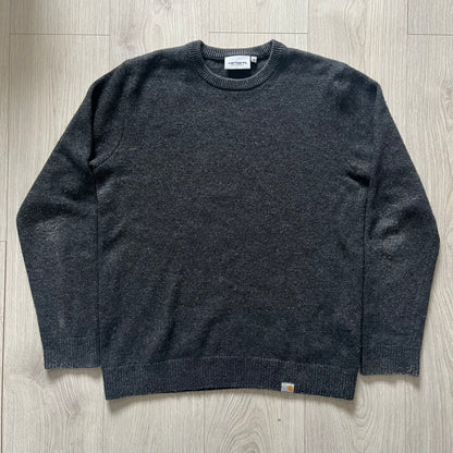  The Carhartt WIP Allen Sweater blends function and refinement in a dark gray wool–nylon knit. Midweight with ribbed details at the neck, cuffs, and hem, it ensures warmth and flexibility. A classic, durable knit that captures the minimal craftsmanship of Carhartt WIP.
