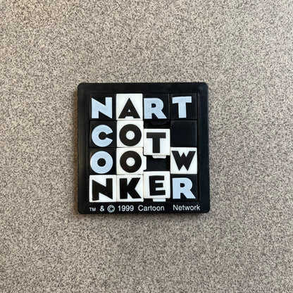 Cartoon Network 1999 Logo Puzzle is a handheld sliding tile puzzle featuring the classic Cartoon Network logo. The movable square tiles each display a single black or white letter, allowing the logo to be rearranged by sliding the pieces into place. Official 1999 licensing is printed on the bottom of the puzzle frame.