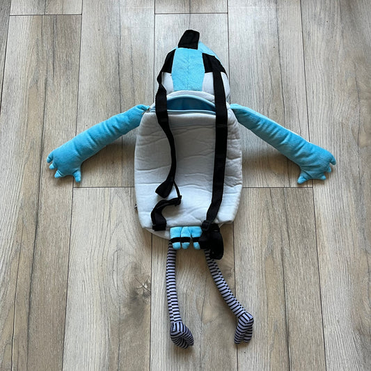 Cartoon Network Regular Show Mordecai 2016 Backpack is a full-body backpack featuring Mordecai with movable arms and legs. The straps attach from top to bottom, and the design shows his blue and light blue coloring, black head markings, striped wings, and tail feathers. The backpack replicates Mordecai’s animated appearance, including his crested head feathers and grey striped legs.