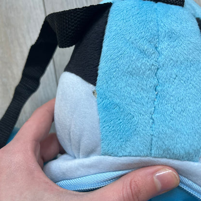 Cartoon Network Regular Show Mordecai 2016 Backpack is a full-body backpack featuring Mordecai with movable arms and legs. The straps attach from top to bottom, and the design shows his blue and light blue coloring, black head markings, striped wings, and tail feathers. The backpack replicates Mordecai’s animated appearance, including his crested head feathers and grey striped legs.
