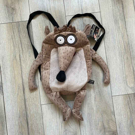 Cartoon Network Regular Show Rigby 2016 Backpack is a character-shaped backpack designed as Rigby from the animated series Regular Show. The bag features a full plush body construction with movable arms, legs, and mouth, while the eyes and mouth are finished with embroidered detailing. Adjustable straps are attached from the top to the lower back of the character, allowing it to be worn as a standard backpack. The design follows Rigby’s appearance with brown fur tones, dark raccoon-style eye mask markings, 