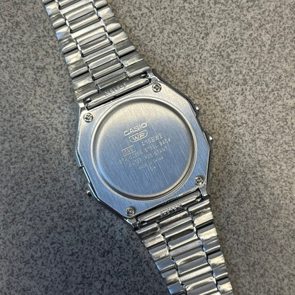 Custom Casio A158 "Chrome" Silver Digital Watch (A158WEA-7EF) is a custom Casio digital watch with a reflective silver filter over the square resin glass screen and a stainless steel band with an adjustable clasp, compatible with wrist sizes from 150 to 205 mm. It has a 1/100-second stopwatch, a daily alarm, an hourly time signal, an auto-calendar, a 12/24-hour format, a green LED light, and water resistance.