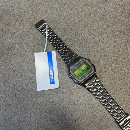 Custom Casio A158 “Emerald” Green &amp; Black Digital Watch is a watch with a green gradient filter over the square screen and a grey ion-plated stainless steel band with an adjustable clasp. The case comes with a resin glass and a resin and black chrome-plated case and bezel. It has a 1/100-second stopwatch, a daily alarm, an hourly time signal, an auto-calendar, a 12/24-hour format, a green LED light, and water resistance.