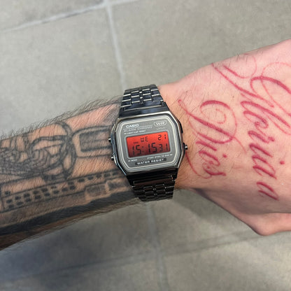 Custom Casio A158 "Red Moon" Black &amp; Red Digital Watch is a watch with a red gradient filter over the square screen and a grey ion-plated stainless steel band with an adjustable clasp. The case comes with a resin glass and a resin and black chrome-plated case and bezel. It has a 1/100-second stopwatch, a daily alarm, an hourly time signal, an auto-calendar, a 12/24-hour format, a green LED light, and water resistance.