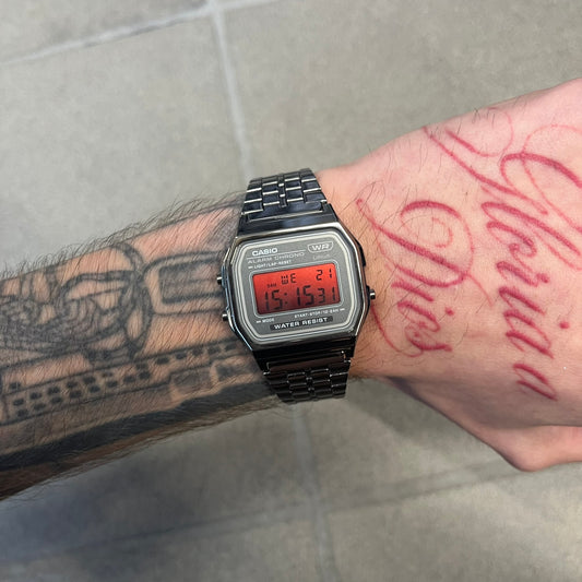 Custom Casio A158 "Red Moon" Black &amp; Red Digital Watch is a watch with a red gradient filter over the square screen and a grey ion-plated stainless steel band with an adjustable clasp. The case comes with a resin glass and a resin and black chrome-plated case and bezel. It has a 1/100-second stopwatch, a daily alarm, an hourly time signal, an auto-calendar, a 12/24-hour format, a green LED light, and water resistance.