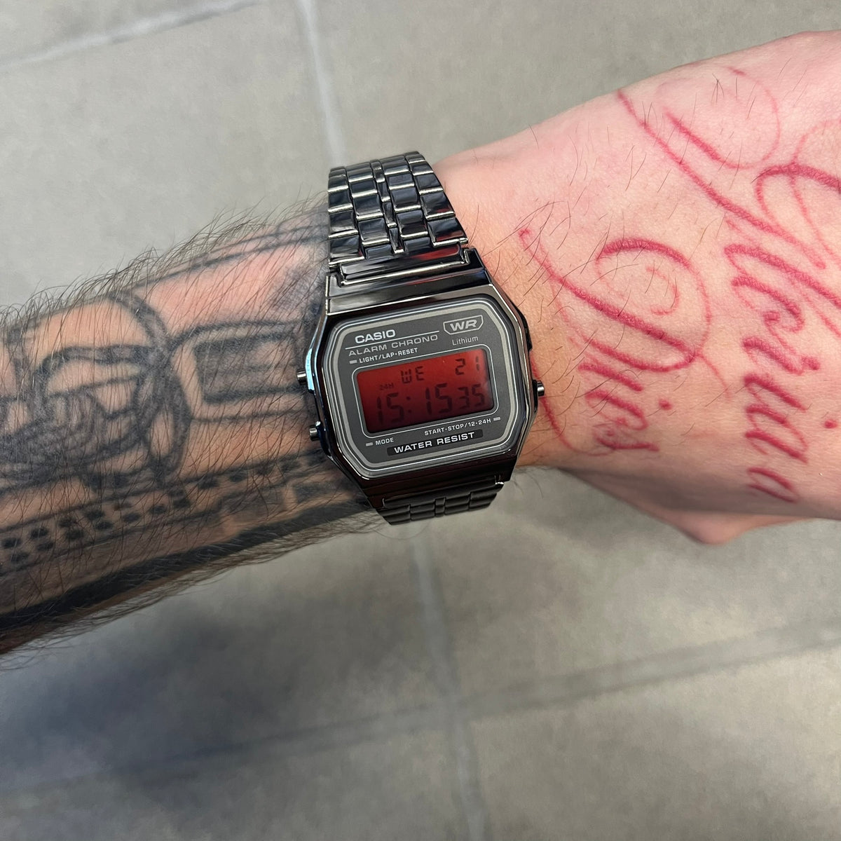 Custom Casio A158 "Red Moon" Black &amp; Red Digital Watch is a watch with a red gradient filter over the square screen and a grey ion-plated stainless steel band with an adjustable clasp. The case comes with a resin glass and a resin and black chrome-plated case and bezel. It has a 1/100-second stopwatch, a daily alarm, an hourly time signal, an auto-calendar, a 12/24-hour format, a green LED light, and water resistance.