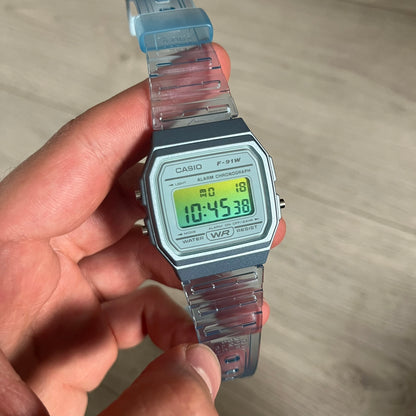 Custom Casio F-91W Blue digital watch featuring a Gradient Blue and green filter screen. Slim 8.5 mm profile, lightweight 21 g build and flexible bio-based resin band ensure lasting comfort. Includes alarm, stopwatch, and microlight function for everyday functionality.