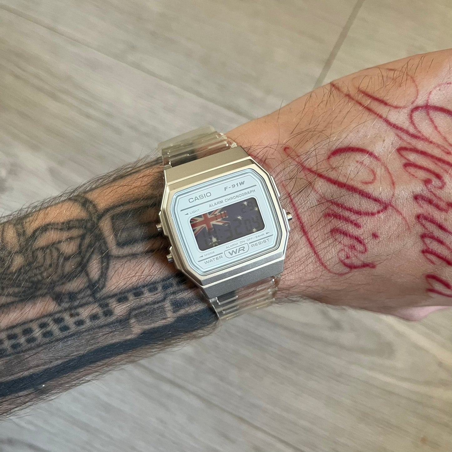 Custom Casio F-91W Clear/Transparent digital watch featuring a Australia Flag filter screen. Slim 8.5 mm profile, lightweight 21 g build and flexible bio-based resin band ensure lasting comfort. Includes alarm, stopwatch, and microlight function for everyday functionality.