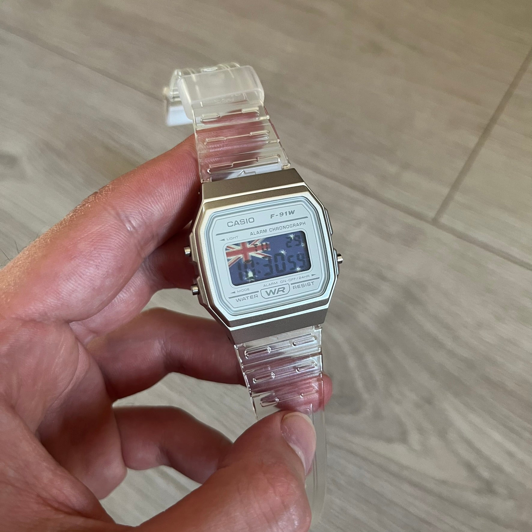 Custom Casio F-91W Clear/Transparent digital watch featuring a Australia Flag filter screen. Slim 8.5 mm profile, lightweight 21 g build and flexible bio-based resin band ensure lasting comfort. Includes alarm, stopwatch, and microlight function for everyday functionality.