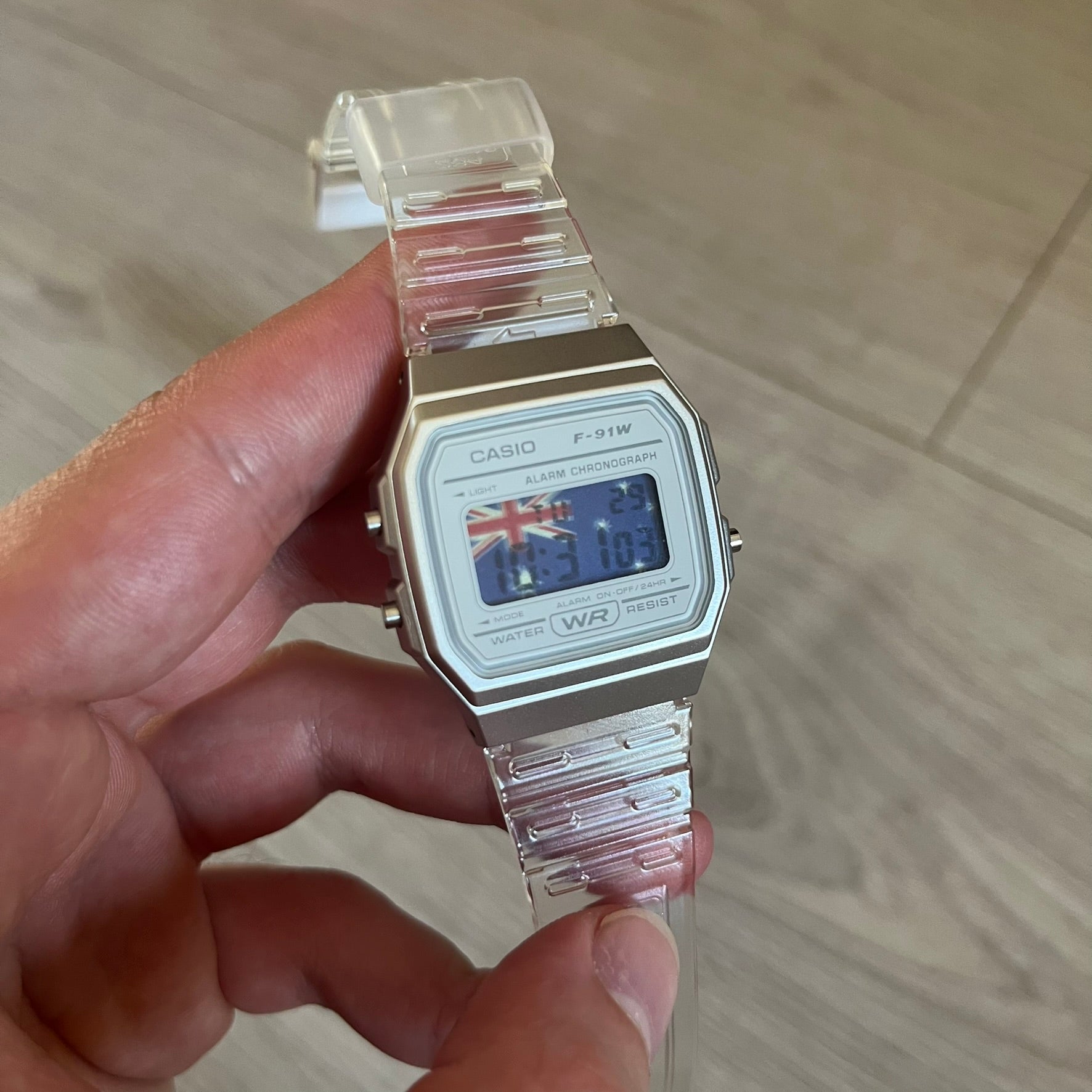 Custom Casio F-91W Clear/Transparent digital watch featuring a Australia Flag filter screen. Slim 8.5 mm profile, lightweight 21 g build and flexible bio-based resin band ensure lasting comfort. Includes alarm, stopwatch, and microlight function for everyday functionality.
