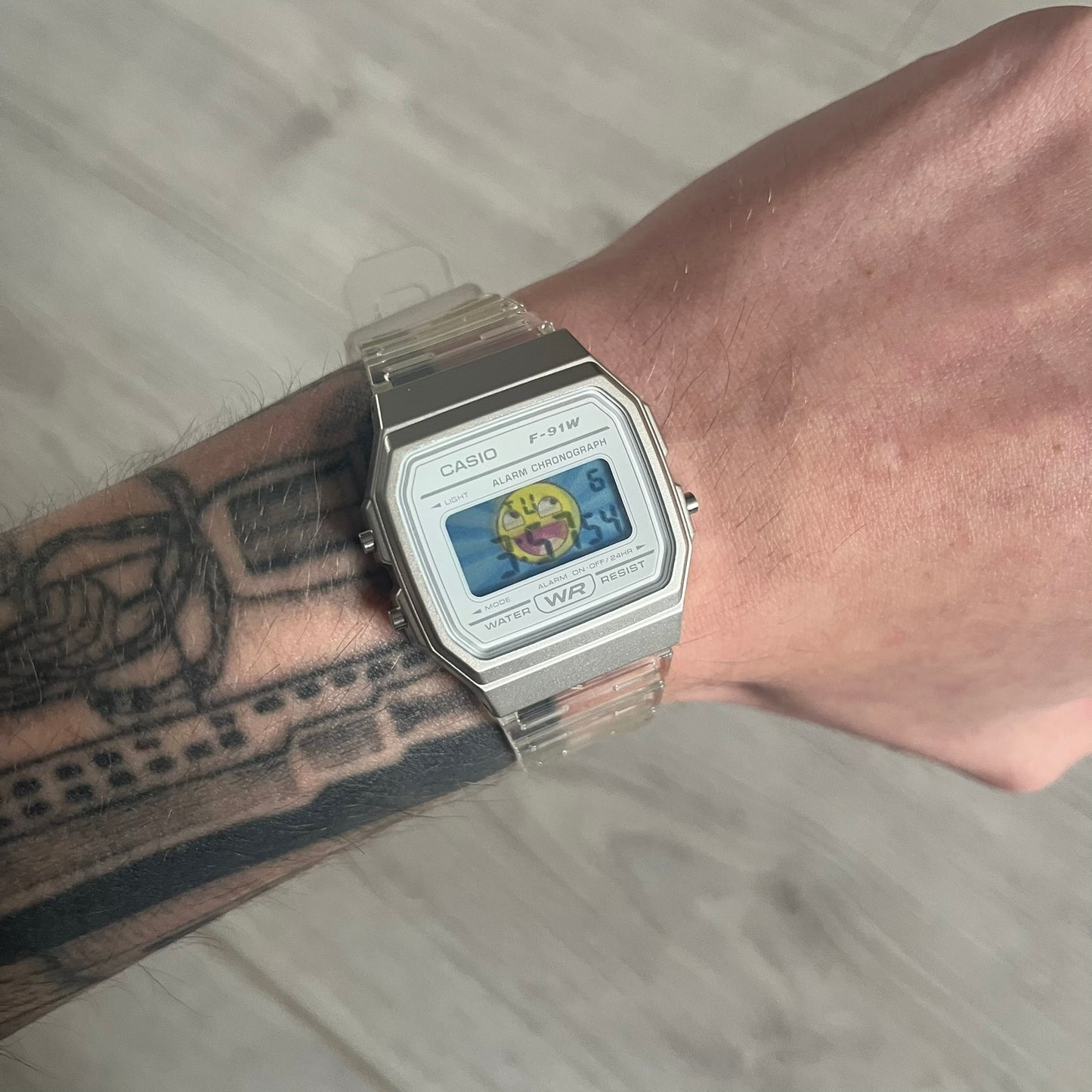 Custom Casio F-91W Clear/Transparent digital watch featuring a Awesome Face filter screen. Slim 8.5 mm profile, lightweight 21 g build and flexible bio-based resin band ensure lasting comfort. Includes alarm, stopwatch, and microlight function for everyday functionality.