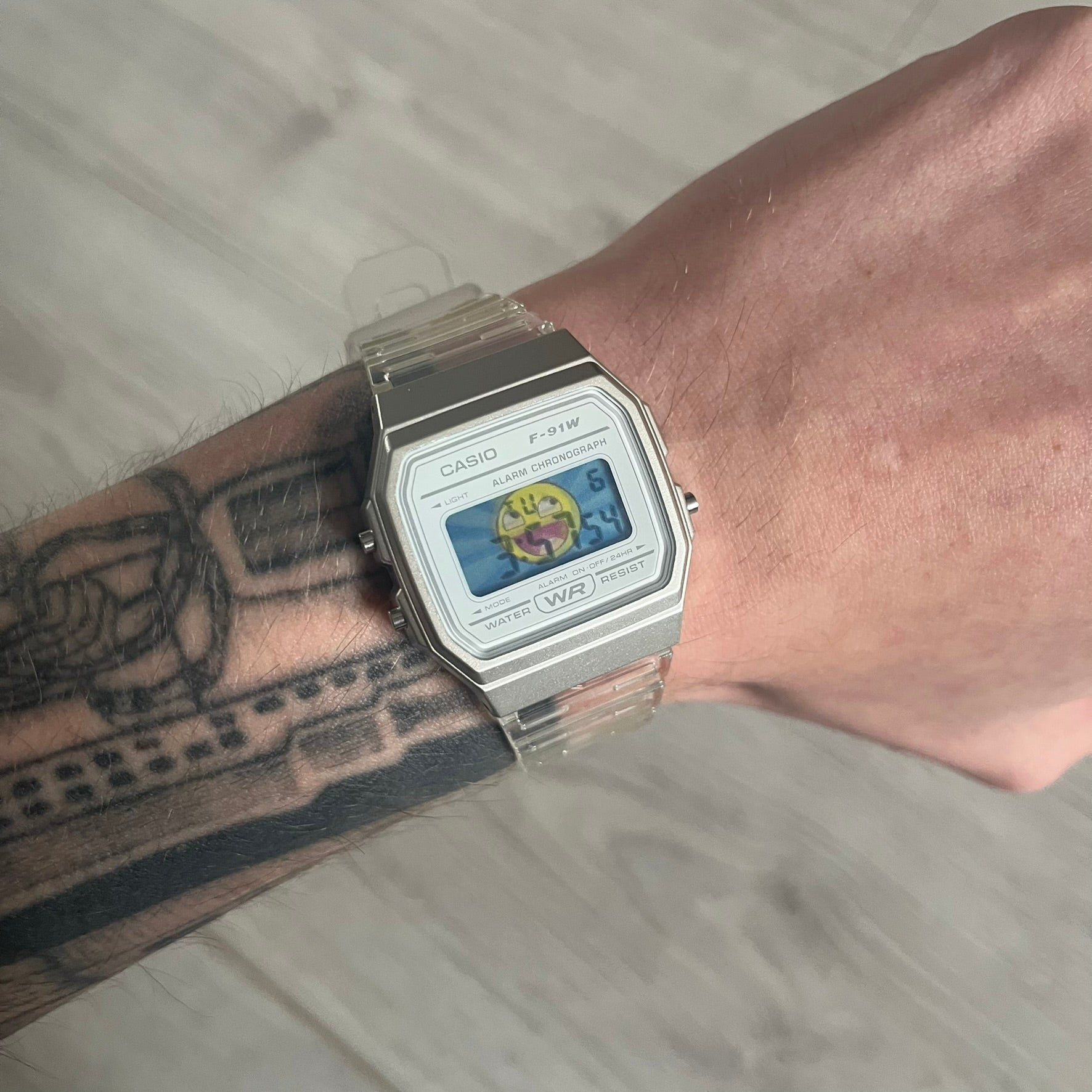 Custom Casio F-91W Clear/Transparent digital watch featuring a Awesome Face filter screen. Slim 8.5 mm profile, lightweight 21 g build and flexible bio-based resin band ensure lasting comfort. Includes alarm, stopwatch, and microlight function for everyday functionality.