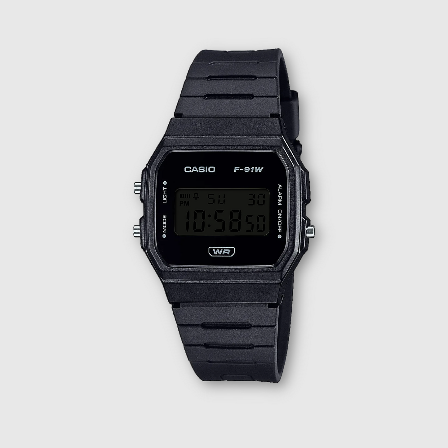 Black Casio digital watch on a light gray background