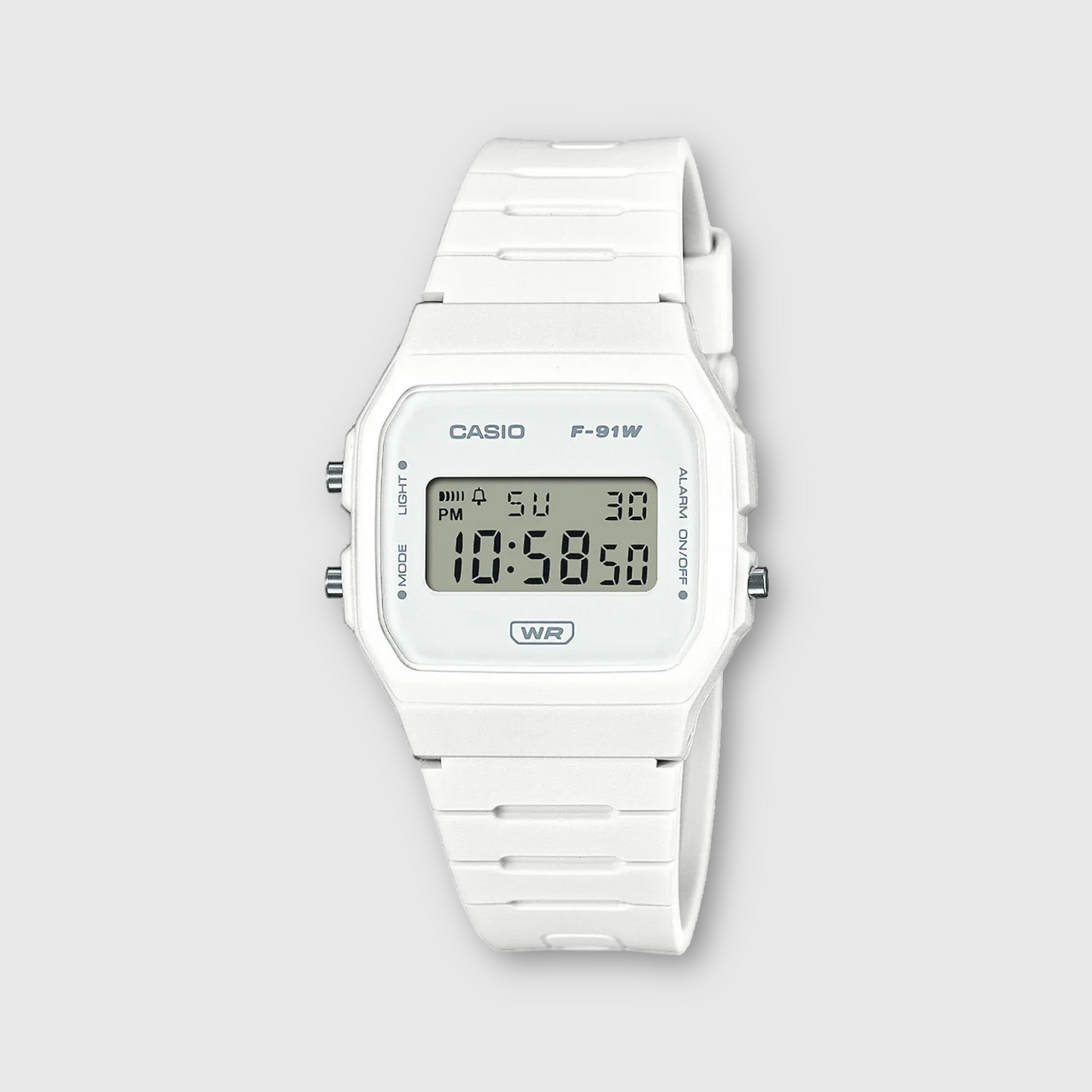 White Casio digital watch on a light gray background