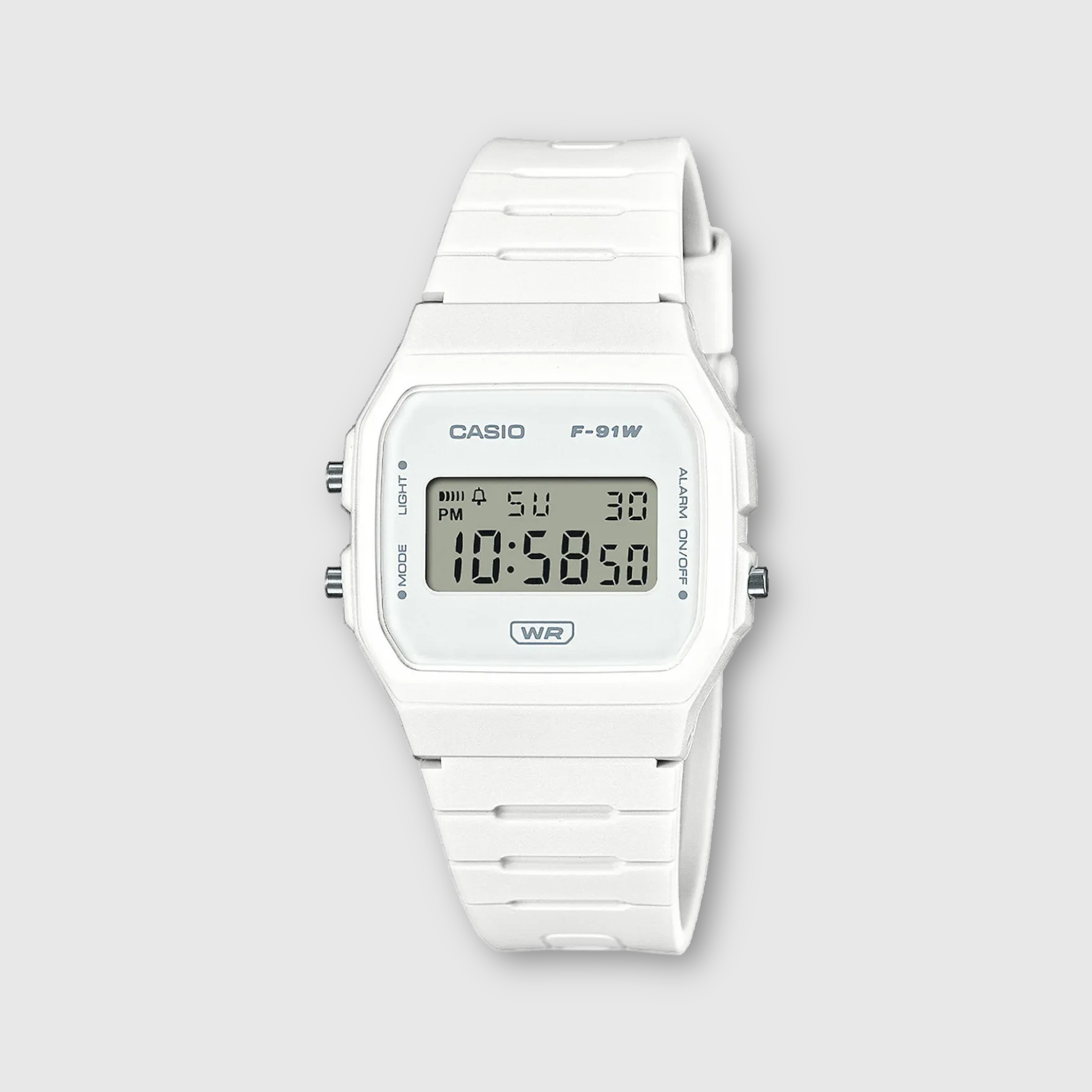 White Casio digital watch on a light gray background