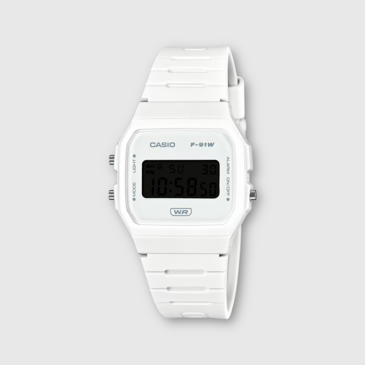 White Casio digital watch on a light gray background