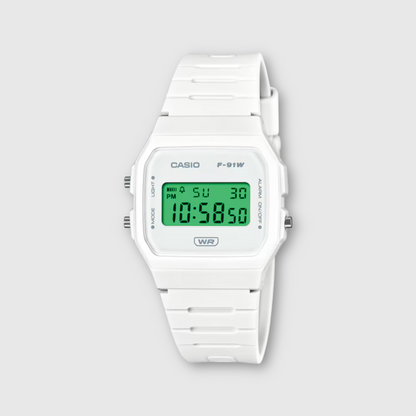 White Casio digital watch with green display on a light gray background