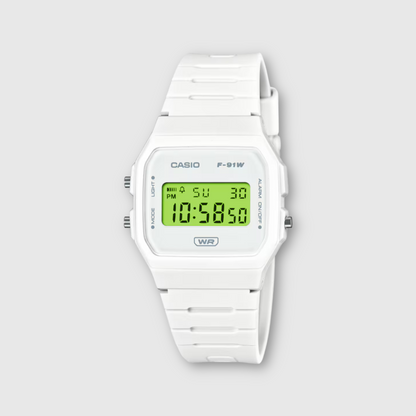 White Casio digital watch with green display on a light gray background