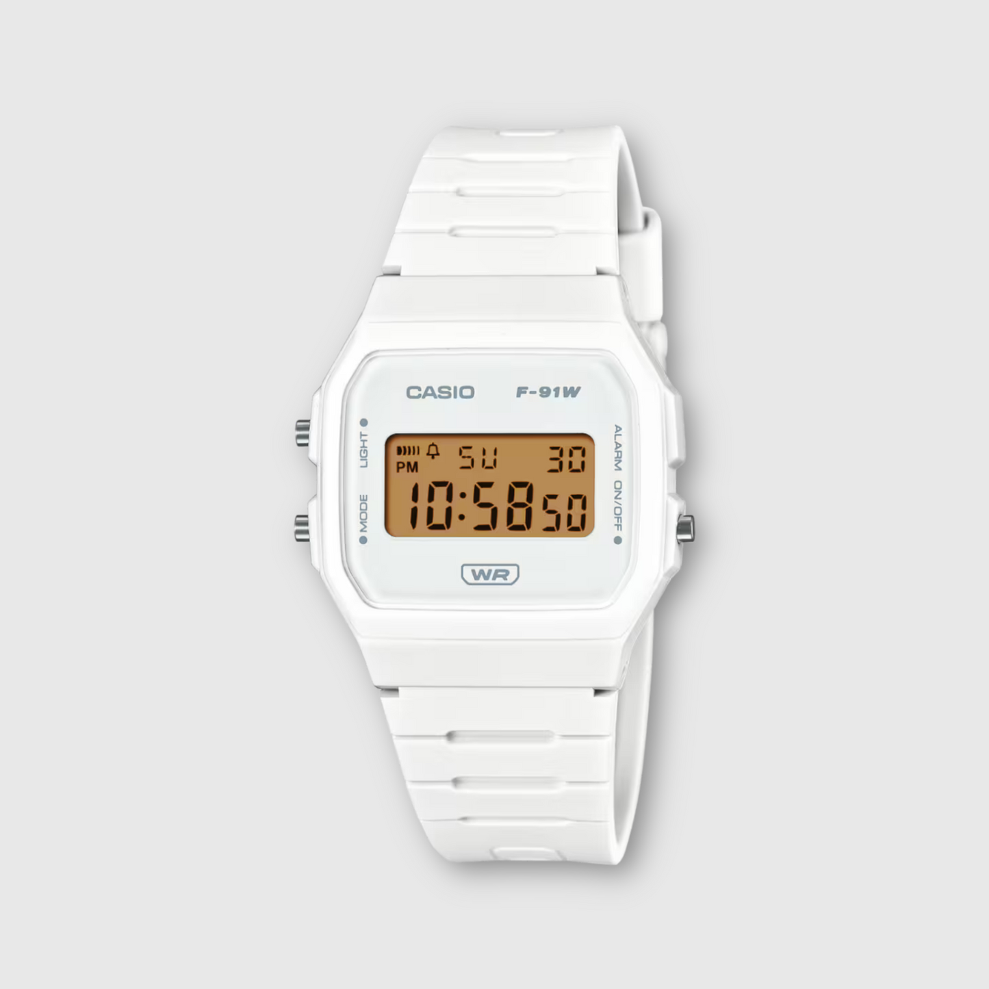 White Casio digital watch on a light gray background