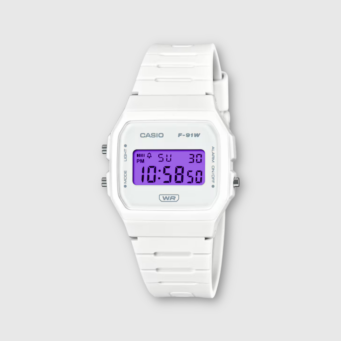 White Casio digital watch on a light gray background