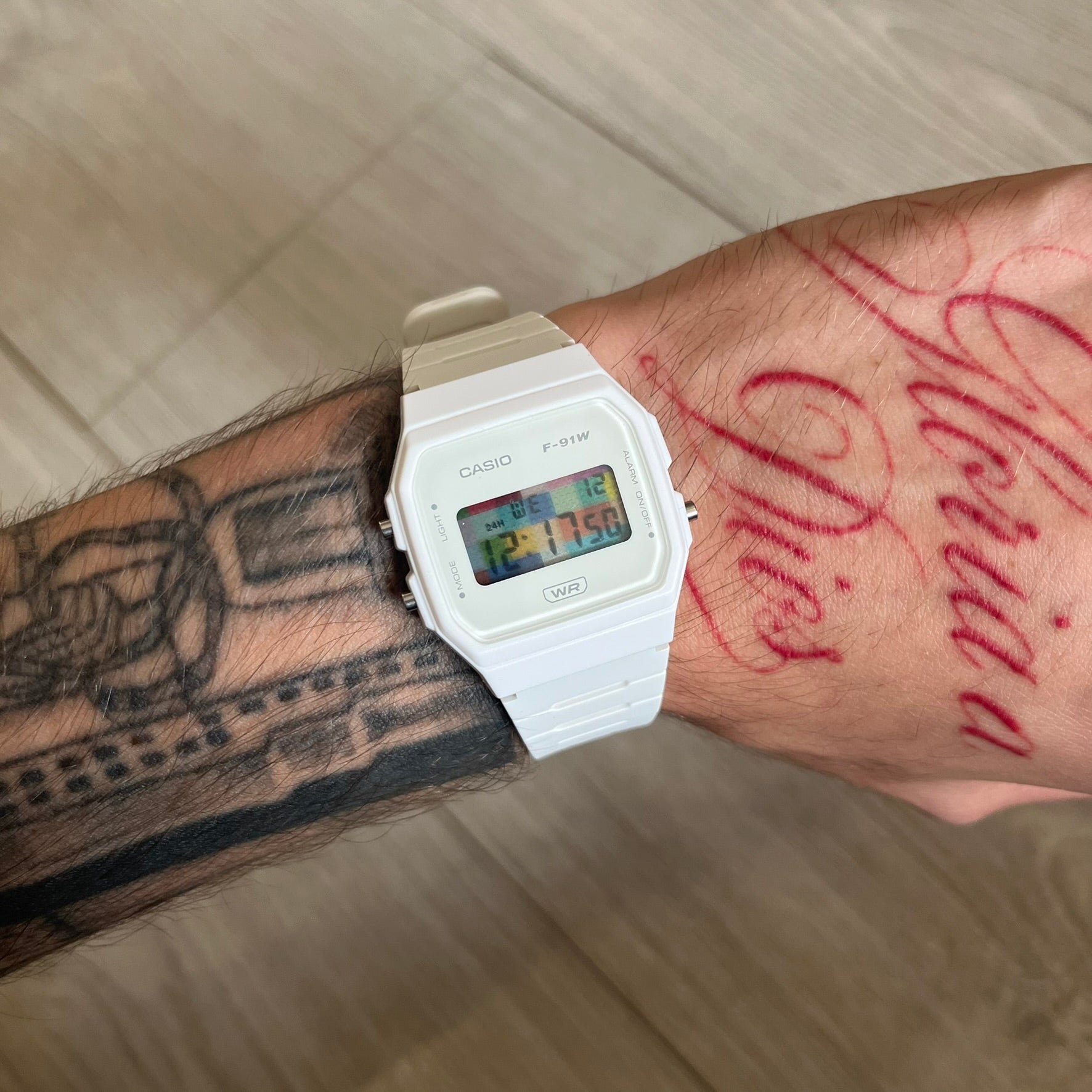 Custom Casio F-91W White digital watch featuring a Multicolor interlocking bricks filter screen. Slim 8.5 mm profile, lightweight 21 g build and flexible bio-based resin band ensure lasting comfort. Includes alarm, stopwatch, and microlight function for everyday functionality.