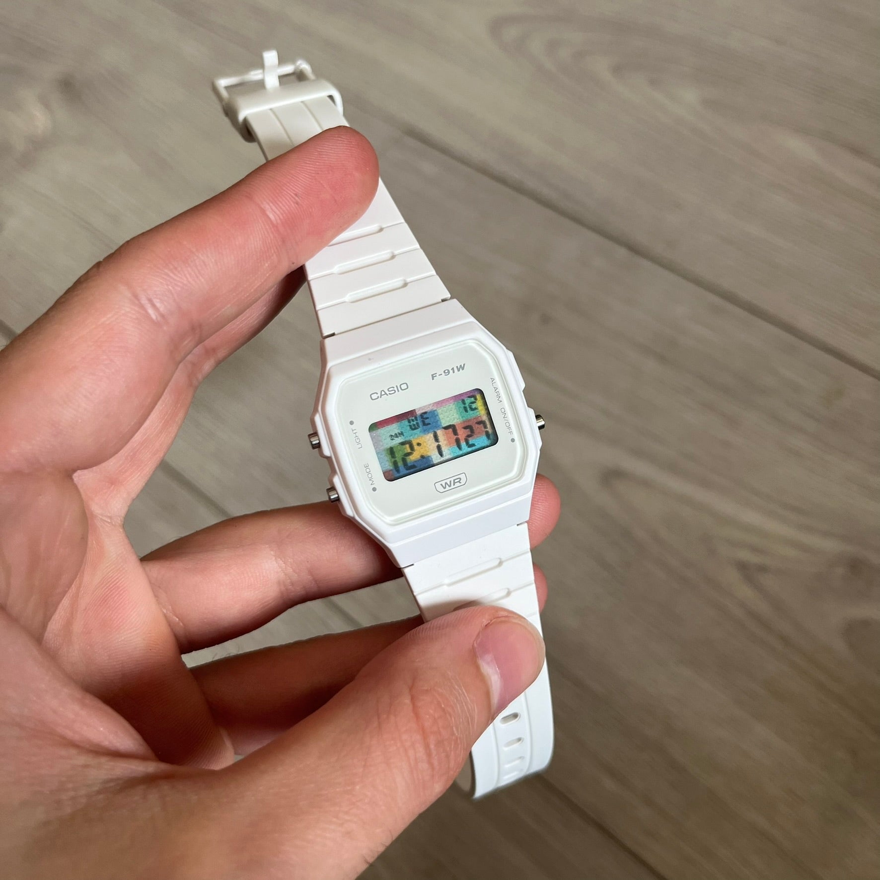 Custom Casio F-91W White digital watch featuring a Multicolor interlocking bricks filter screen. Slim 8.5 mm profile, lightweight 21 g build and flexible bio-based resin band ensure lasting comfort. Includes alarm, stopwatch, and microlight function for everyday functionality.