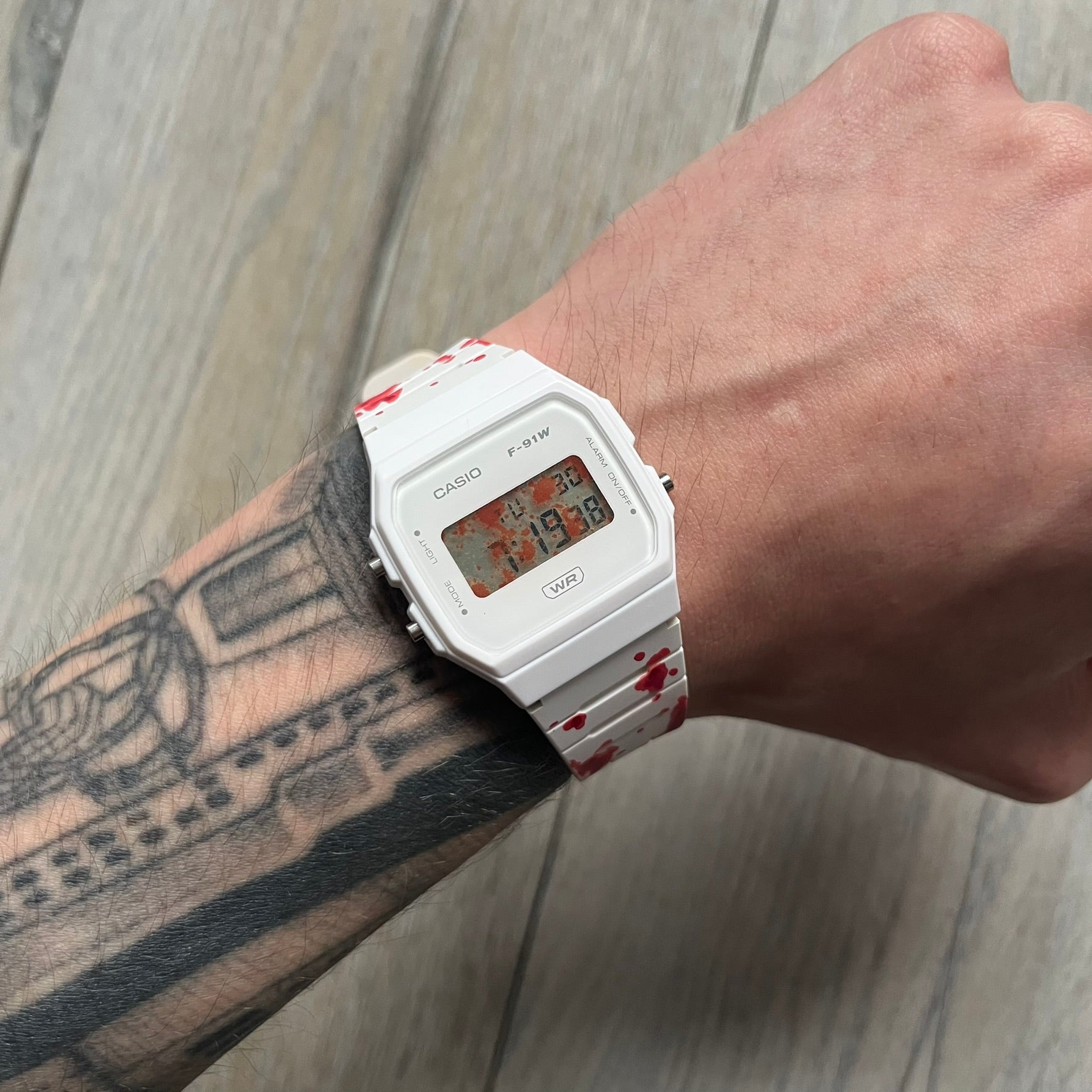 Custom Casio F-91W White digital watch featuring a Bloody filter screen and custom painted straps. Slim 8.5 mm profile, lightweight 21 g build and flexible bio-based resin band ensure lasting comfort. Includes alarm, stopwatch, and microlight function for everyday functionality.

This watch is a 1/1 sample. The paint on the straps is not holding perfectly as with more force it can be smudged. For the best effect we reccomend covering it with a special paint or spray to make it 100% last.&nbsp;