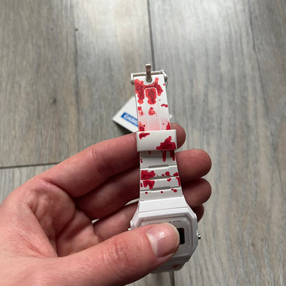 Custom Casio F-91W White digital watch featuring a Bloody filter screen and custom painted straps. Slim 8.5 mm profile, lightweight 21 g build and flexible bio-based resin band ensure lasting comfort. Includes alarm, stopwatch, and microlight function for everyday functionality.

This watch is a 1/1 sample. The paint on the straps is not holding perfectly as with more force it can be smudged. For the best effect we reccomend covering it with a special paint or spray to make it 100% last.&nbsp;