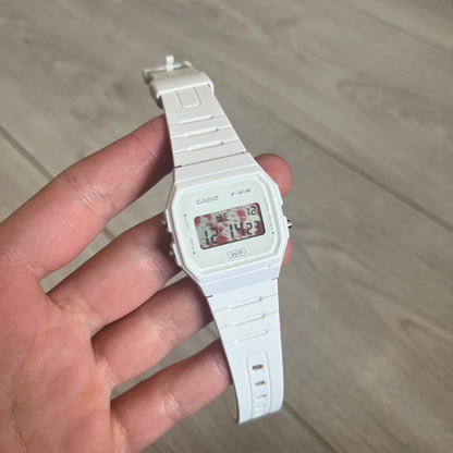 Custom Casio F-91W White digital watch featuring a Bloody filter screen. Slim 8.5 mm profile, lightweight 21 g build and flexible bio-based resin band ensure lasting comfort. Includes alarm, stopwatch, and microlight function for everyday functionality.