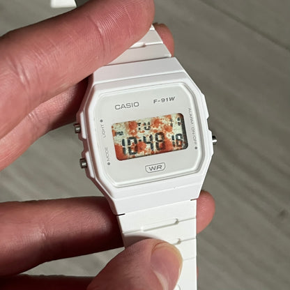 Custom Casio F-91W White digital watch featuring a Bloody filter screen. Slim 8.5 mm profile, lightweight 21 g build and flexible bio-based resin band ensure lasting comfort. Includes alarm, stopwatch, and microlight function for everyday functionality.