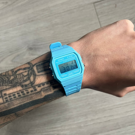 Custom Casio F-91W Baby Blue digital watch featuring a Gradient Blue filter screen. Slim 8.5 mm profile, lightweight 21 g build and flexible bio-based resin band ensure lasting comfort. Includes alarm, stopwatch, and microlight function for everyday functionality.