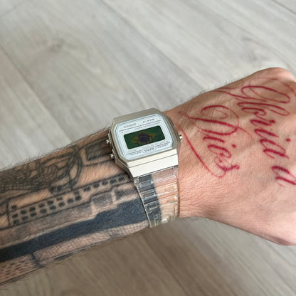 Custom Casio F-91W Clear/Transparent digital watch featuring a Brazil Flag filter screen. Slim 8.5 mm profile, lightweight 21 g build and flexible bio-based resin band ensure lasting comfort. Includes alarm, stopwatch, and microlight function for everyday functionality.