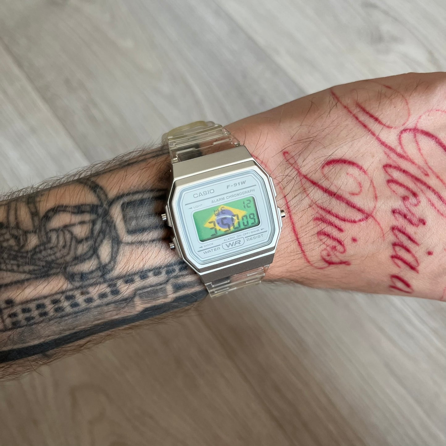 Custom Casio F-91W Clear/Transparent digital watch featuring a Brazil Flag filter screen. Slim 8.5 mm profile, lightweight 21 g build and flexible bio-based resin band ensure lasting comfort. Includes alarm, stopwatch, and microlight function for everyday functionality.