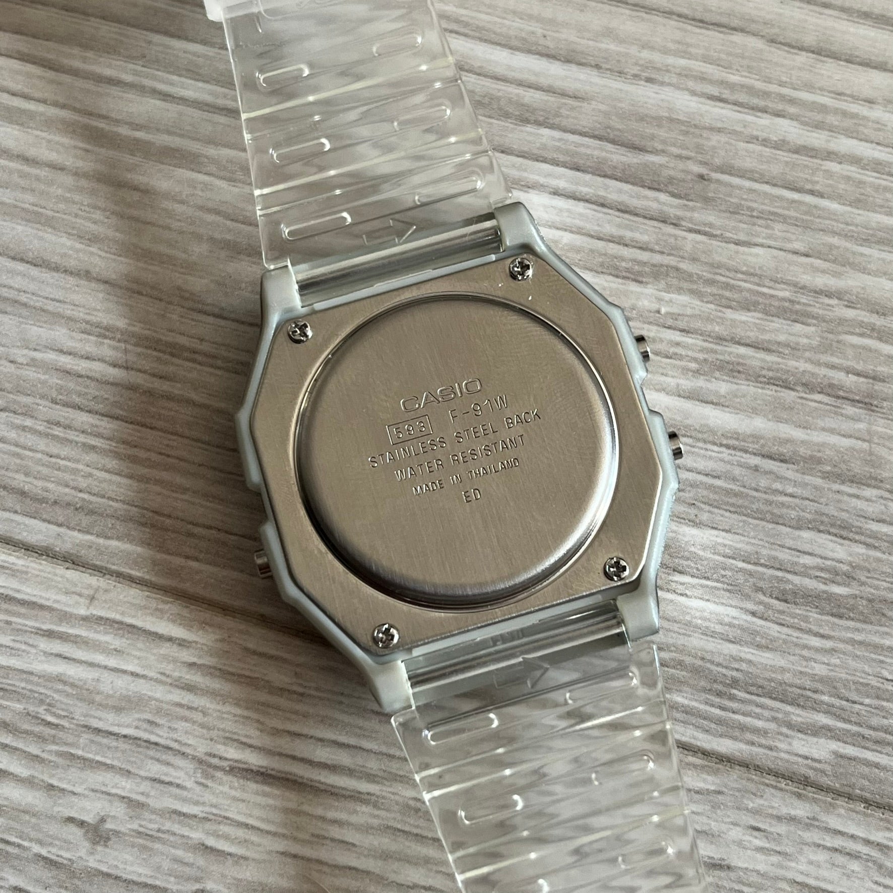 Custom Casio F-91W Clear/Transparent digital watch featuring a Brazil Flag filter screen. Slim 8.5 mm profile, lightweight 21 g build and flexible bio-based resin band ensure lasting comfort. Includes alarm, stopwatch, and microlight function for everyday functionality.